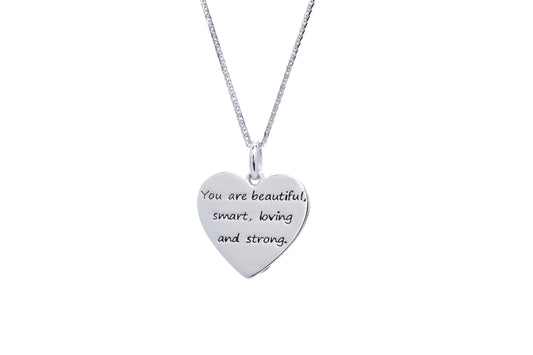 Close up shot of silver plate backdrop of pendant. Engraved message, " You are beautiful, smart, loving and strong."